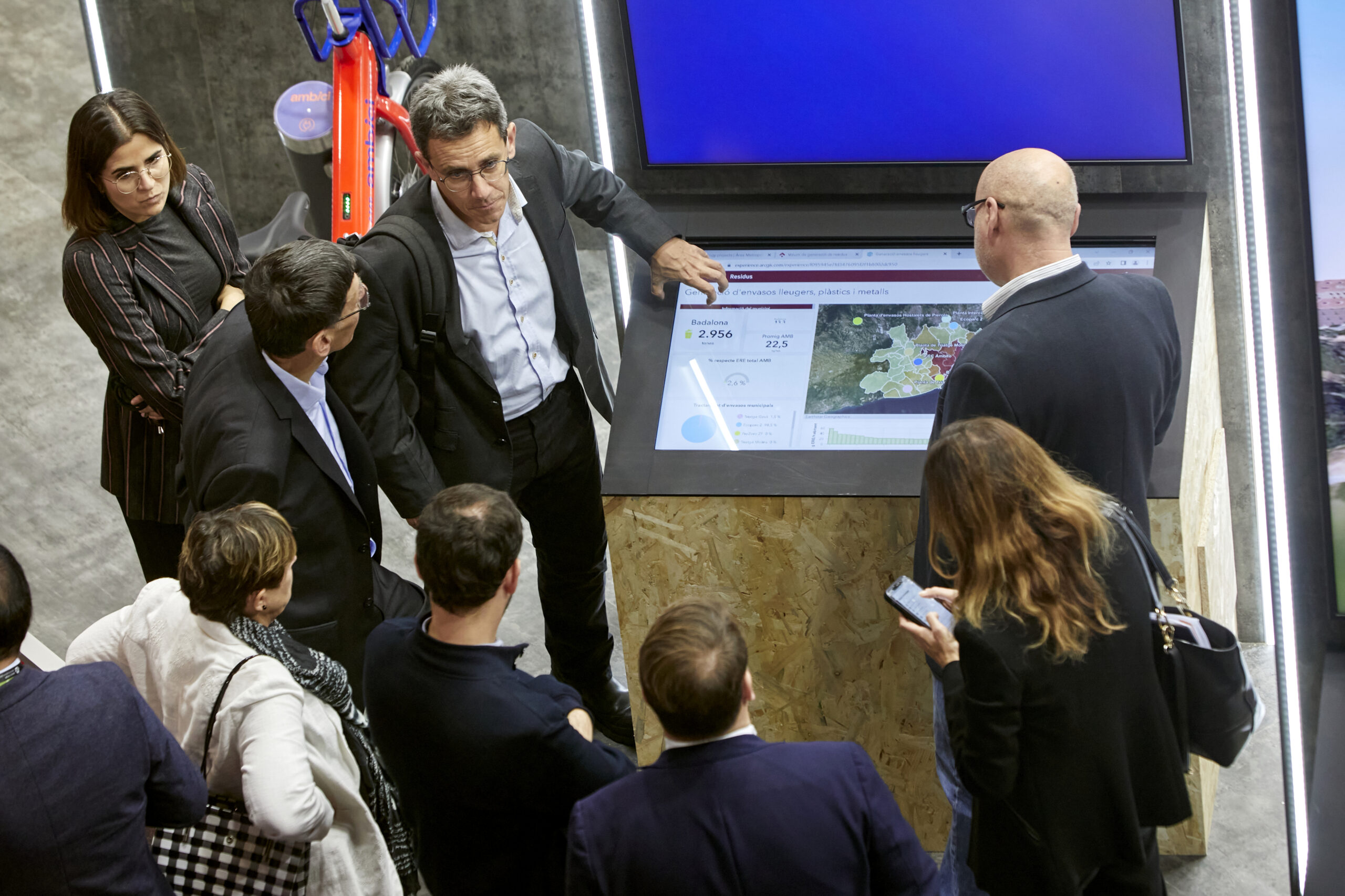 Visitors around a table screen in the exhibition area